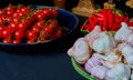 Still life with garlic, chilli and tomatoes on a blue plate Royalty Free Stock Photo