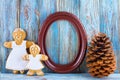 Still life of gingerbread, gingerbread men, brown frame and pine cone on blue wooden background, template greeting card Royalty Free Stock Photo