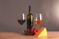 Still life with glass and bottle of wine, cheese and grapes Royalty Free Stock Photo