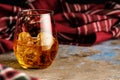 Still-life with a glass of bourbon. A glass of whiskey with ice. Royalty Free Stock Photo