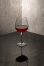 Still life with a glass goblet with wine in the corner Royalty Free Stock Photo
