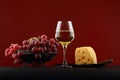 Glass of white wine, grapes and cheese