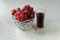 Still life with a glass of wine and a crystal vase with grapes