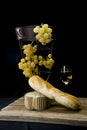 Still life with golden grapes and and white wine on black background Royalty Free Stock Photo