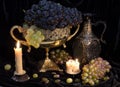 Still life with grape in vase and candles Royalty Free Stock Photo