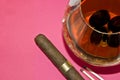 Still Life - grapes in a glass of cognac, cigars a Royalty Free Stock Photo