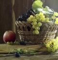 Still life with grapes and red apple