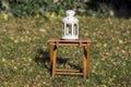 White candlelight lantern in the garden, autumn season