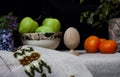 Still life of green apples , tangerines and purple vase with flower Royalty Free Stock Photo