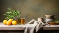 Still life with green olives, olive oil bottle, branch, and napkin on kitchen table Royalty Free Stock Photo