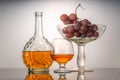 Still life with green and red grapes and wine in a bottle and a glass Royalty Free Stock Photo