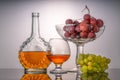 Still life with green and red grapes and wine in a bottle and a glass Royalty Free Stock Photo