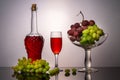 Still life with green and red grapes and wine in a bottle and a glass Royalty Free Stock Photo