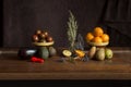 Still life of a group of fruits, vegetables on an elegant chestnut wood table.