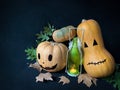 Still life Halloween pumpkins with a glowing candle in a bottle and autumn leaves Royalty Free Stock Photo