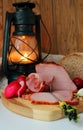 Still life with ham, homemade bread and a lantern Royalty Free Stock Photo