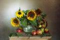 A spectacular bouquet of sunflowers in a vase and apples. Royalty Free Stock Photo