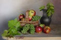 Harvested crop: apples, grapes on a brown background.