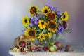 A spectacular bouquet of sunflowers in a vase and apples . Royalty Free Stock Photo