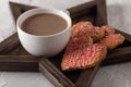 still life of heart shaped cookies decorated with icing and a cup of coffee on a star shaped wooden tray, breakfast Royalty Free Stock Photo