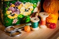 Still life with hobby tools: scissors, coils of thread, little balls of yarn and old lovely metal box Royalty Free Stock Photo