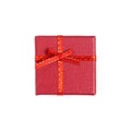 Still life with holiday gift in small red color box, covered with ribbon with bow isolated on white background top view Royalty Free Stock Photo