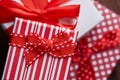 Still life with holiday gift in small red color box with ribbon and bow on wooden background, top view, close-up Royalty Free Stock Photo