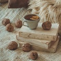 Still life in home interior of living room. Sweaters and cup of tea with a cone on the books. Read. Cozy autumn winter concept Royalty Free Stock Photo