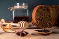 Still life with homemade cake, jar with honey and dipper, cinnamon, dried fruits, star anise on a wooden board. Small Royalty Free Stock Photo