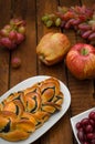 Still life of homemade pastries, sweet poppy pie on the background of fresh fruits, apples and grapes