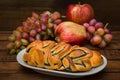 Still life of homemade pastries, sweet poppy pie on the background of fresh fruits, apples and grapes