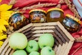 Still life of honey jars, sunflowers and green apples in a basket. Royalty Free Stock Photo