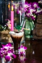 Still life with Iced coffee with cream orchid flowers burning ca Royalty Free Stock Photo