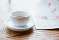 Still life image of cup of black coffee with fresh sport newspaper on the wooden table next to big coffee shop window Royalty Free Stock Photo