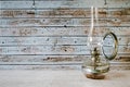 Old rusty gas lamp lit on vintage table Royalty Free Stock Photo