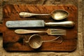 Still life image with old spoon, knife , fork and strainer