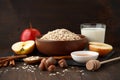 Still life of ingredients for healthy breakfast: rolled oat flakes, milk, apple, honey, hazelnut, cinnamon. Royalty Free Stock Photo