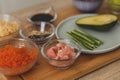 Still life ingredients for making sushi. Master is serving fresh delicious rolls on the wooden board Royalty Free Stock Photo