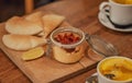 Still life inside a cafe with wooden tables and snack food. Appetizer hummus, pita bread and tea with lemon for lunch Royalty Free Stock Photo