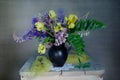 Still life with irises and lupines in a vase on the table Royalty Free Stock Photo