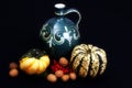 Still-life with a jug, decoration pumpkins an nuts