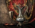 Still life with jug wine, metal goblet and a pomegranate