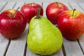 Still life with large green pear and red apples Royalty Free Stock Photo