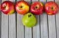 Still life with large green pear and red apples Royalty Free Stock Photo