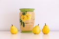 Still life with large hand painted vintage vase and yellow pears