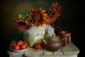 Bouquet of sunflowers and ripe tomatoes on the table . Royalty Free Stock Photo