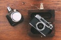 Still life leather, silver hip flask, old camera and dark wood box on wooden surface. Antiques Royalty Free Stock Photo