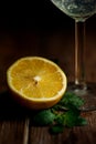 Still life of lemon, cocktail glass and mint leaf on a wooden table Royalty Free Stock Photo