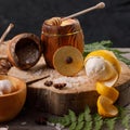 Still life with lemon and honey, on a wooden background in a rustic style. The concept of treating colds. Ethnoscience