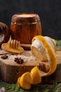 Still life with lemon and honey, on a wooden background in a rustic style. The concept of treating colds. Ethnoscience